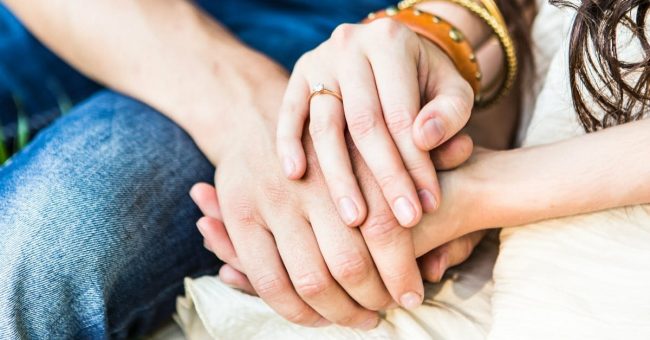A couple holding hands together
